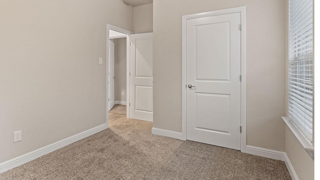 unfurnished bedroom featuring light colored carpet