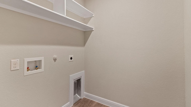 washroom featuring hardwood / wood-style flooring, washer hookup, hookup for an electric dryer, and gas dryer hookup