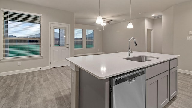 kitchen with sink, gray cabinetry, hanging light fixtures, a center island with sink, and dishwasher