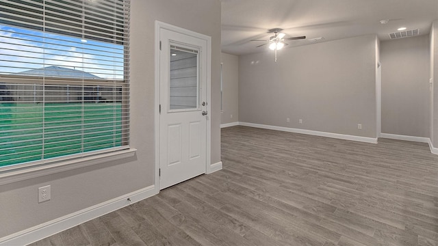 spare room with ceiling fan and wood-type flooring