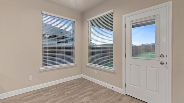 doorway to outside with light wood-type flooring