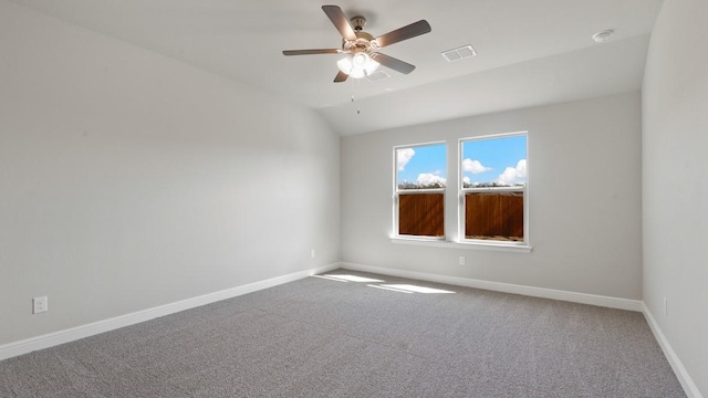 carpeted empty room featuring vaulted ceiling and ceiling fan