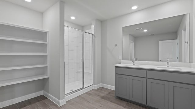 bathroom featuring vanity and a shower with door