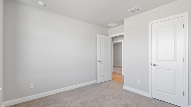 unfurnished bedroom with light carpet