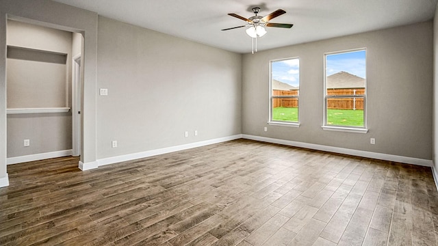 spare room featuring ceiling fan and dark wood-type flooring