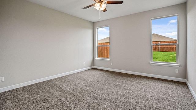 empty room with ceiling fan and carpet floors