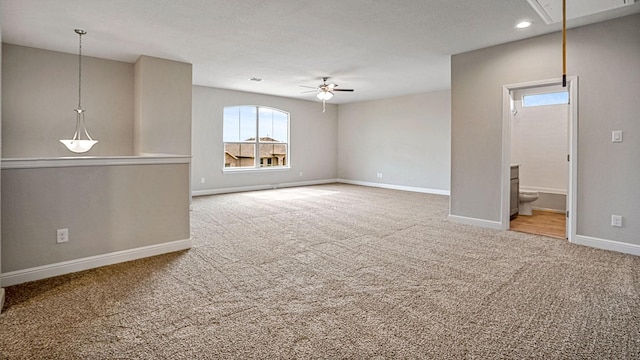 unfurnished living room featuring carpet flooring and ceiling fan