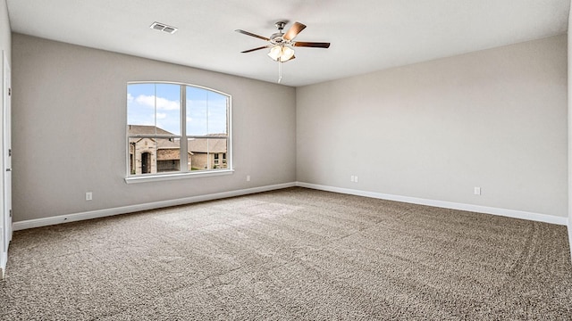 carpeted empty room featuring ceiling fan