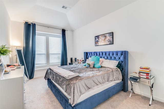 bedroom featuring light colored carpet and vaulted ceiling