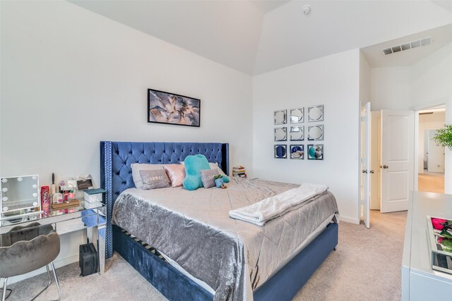 carpeted bedroom with vaulted ceiling