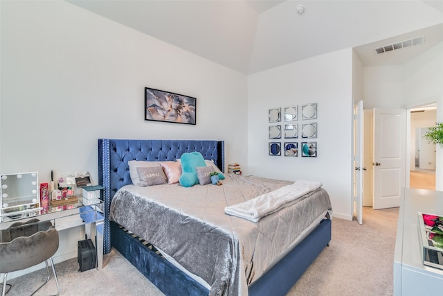 carpeted bedroom with lofted ceiling