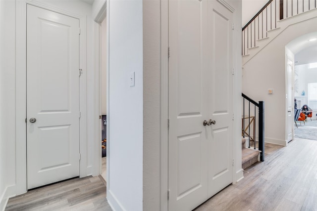 corridor with light hardwood / wood-style flooring