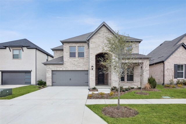 view of front of property with a lawn and a garage