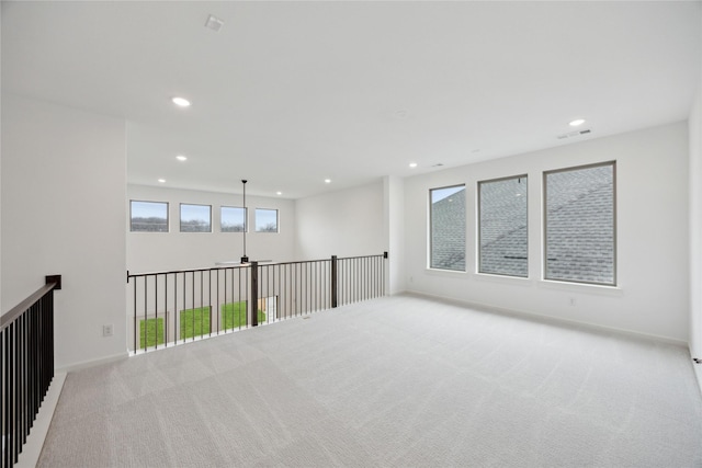 empty room featuring light colored carpet and ceiling fan