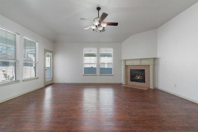 unfurnished living room with ceiling fan, dark hardwood / wood-style floors, a fireplace, and vaulted ceiling