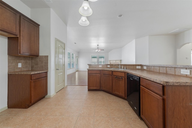 kitchen with ceiling fan, sink, black dishwasher, hanging light fixtures, and light tile patterned flooring