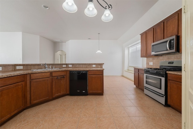 kitchen with pendant lighting, sink, light tile patterned floors, tasteful backsplash, and stainless steel appliances