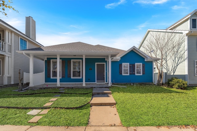 view of front of property with covered porch and a front yard