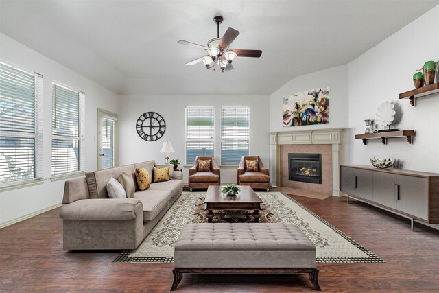 living room with a tile fireplace, lofted ceiling, and dark hardwood / wood-style floors