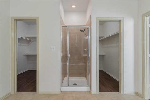 bathroom with tile patterned flooring and a shower with shower door