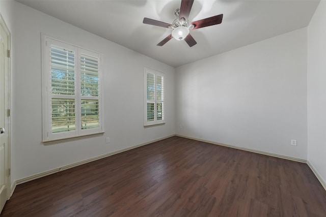 spare room featuring ceiling fan and dark wood-type flooring