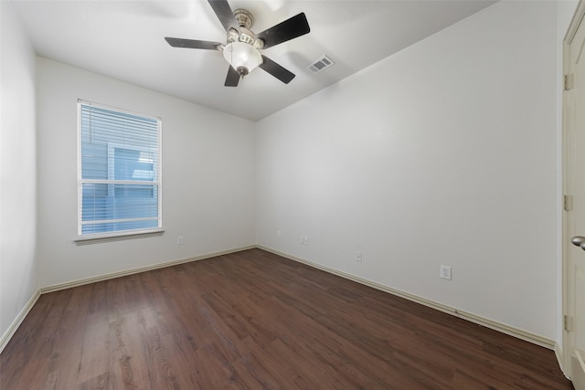 empty room featuring dark hardwood / wood-style flooring and ceiling fan