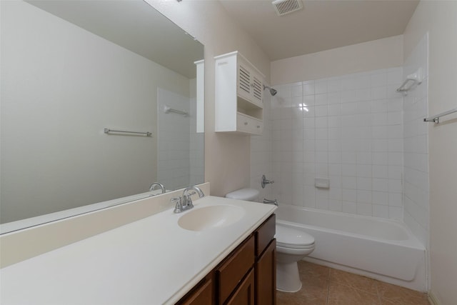 full bathroom featuring tile patterned flooring, vanity, tiled shower / bath combo, and toilet