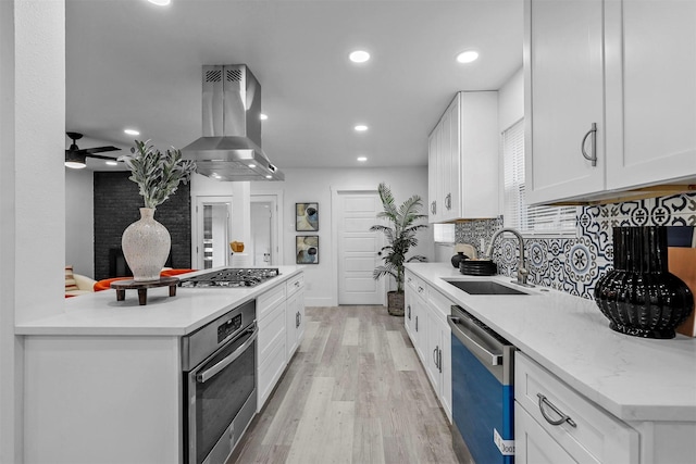 kitchen featuring ventilation hood, sink, white cabinets, and appliances with stainless steel finishes