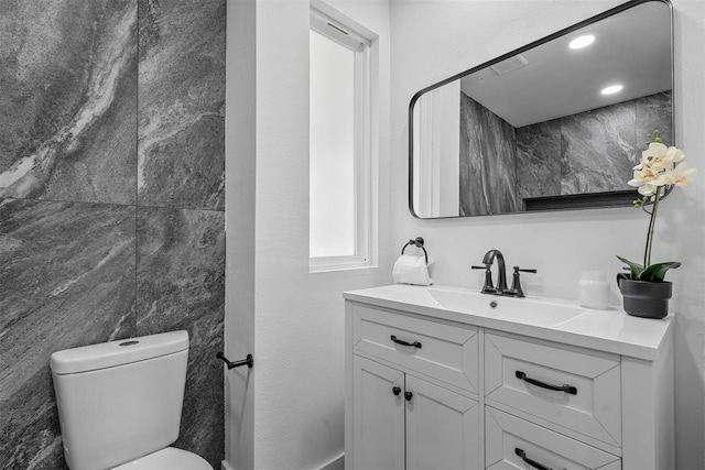 bathroom featuring vanity and toilet