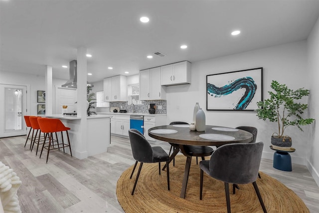 dining room featuring light hardwood / wood-style floors and sink