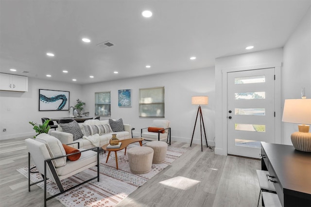 living room with a wealth of natural light and light hardwood / wood-style floors