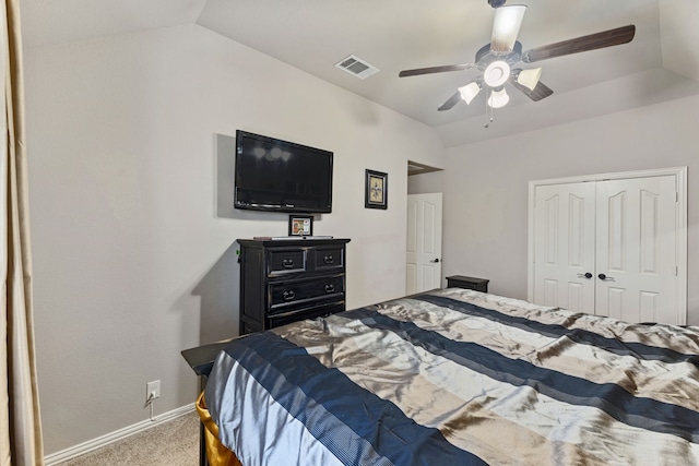 carpeted bedroom featuring ceiling fan, a closet, and vaulted ceiling