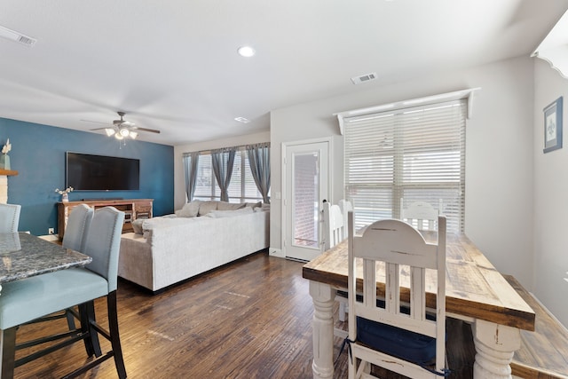 dining room with dark hardwood / wood-style flooring and ceiling fan