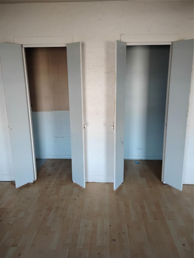 unfurnished bedroom featuring light wood-type flooring