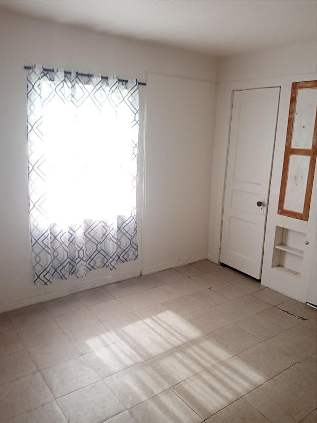 spare room featuring built in shelves