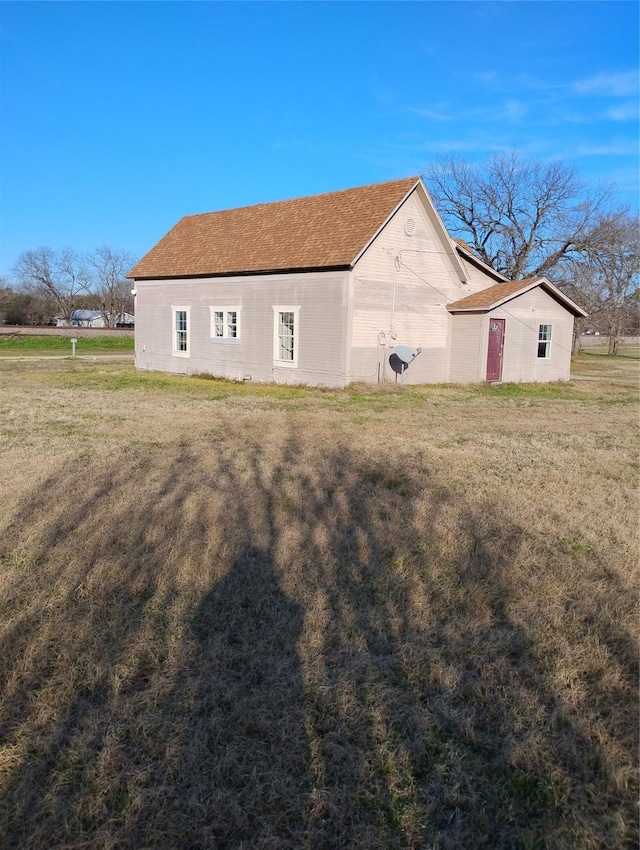 view of side of home featuring a yard