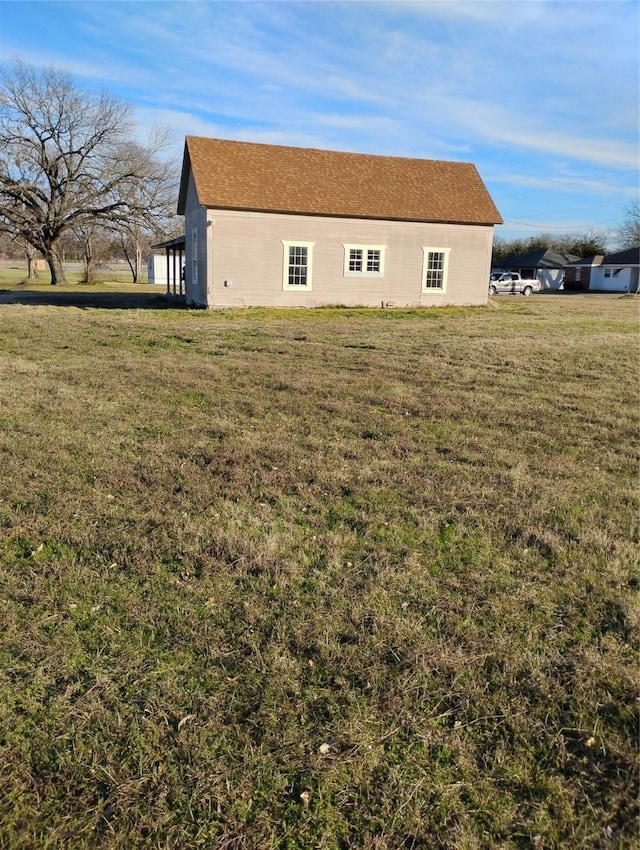 view of side of property with a lawn