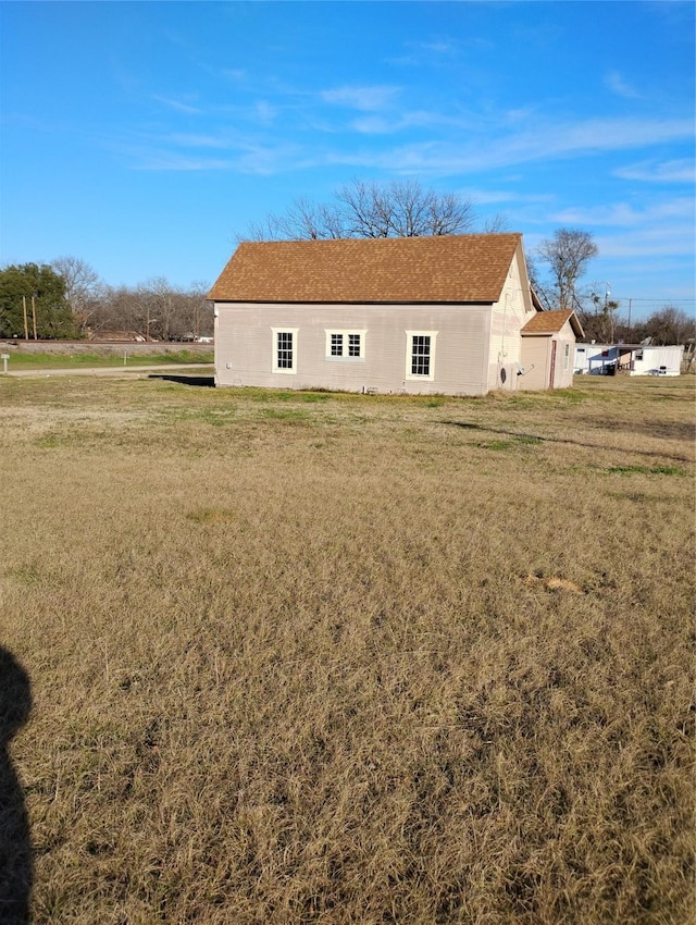 view of side of property featuring a yard