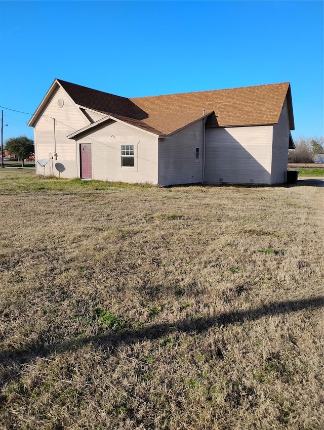 rear view of property with a yard