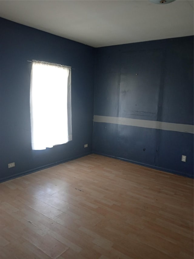 spare room featuring light hardwood / wood-style flooring