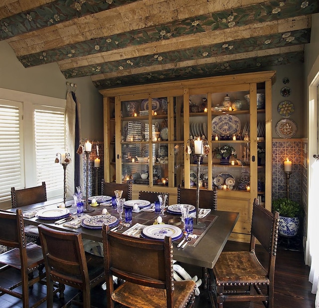 dining room with beamed ceiling and wood-type flooring