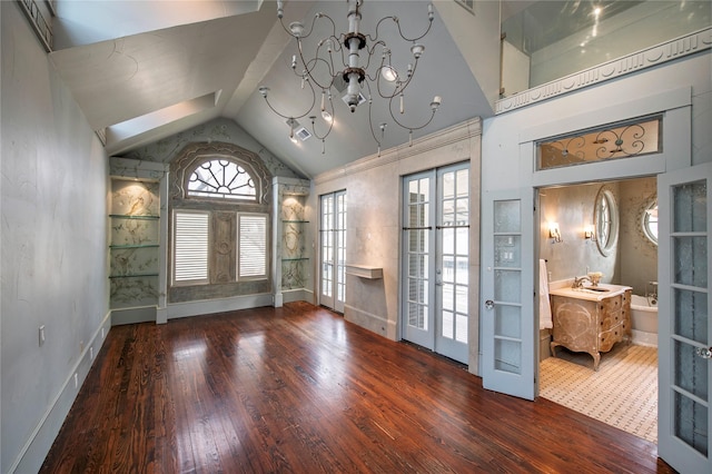 unfurnished room featuring french doors, built in features, and wood-type flooring