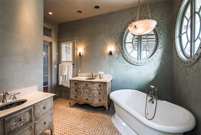 bathroom featuring a washtub and vanity