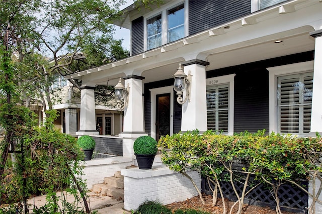 view of exterior entry with covered porch