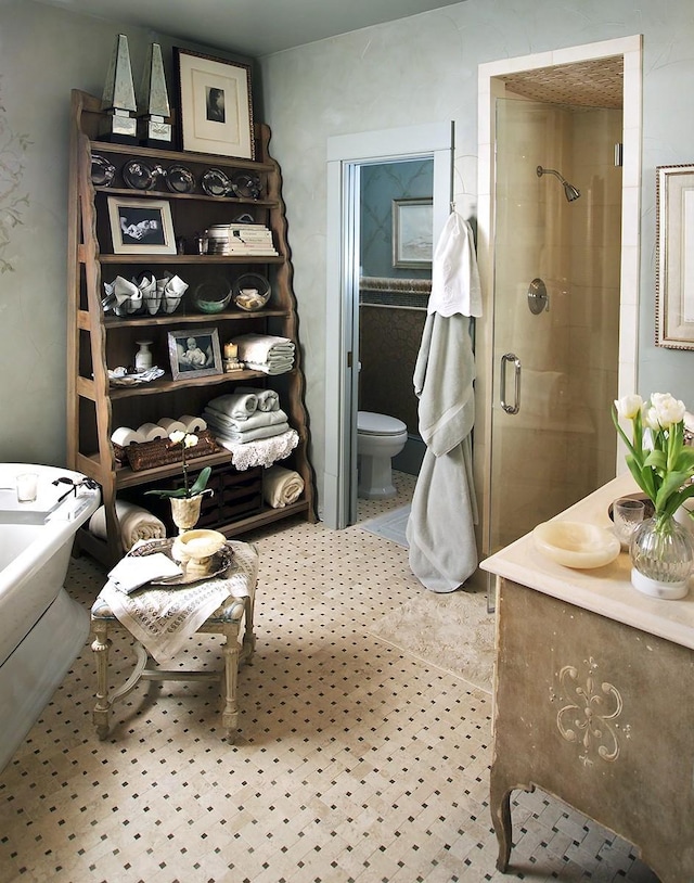 bathroom with tile patterned flooring, toilet, an enclosed shower, and vanity