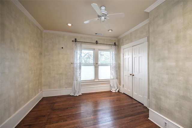 spare room featuring ceiling fan, crown molding, and dark wood-type flooring