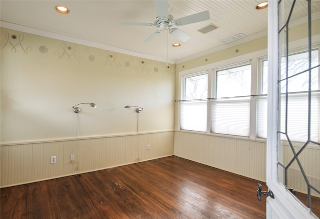 spare room with ornamental molding, ceiling fan, and dark wood-type flooring