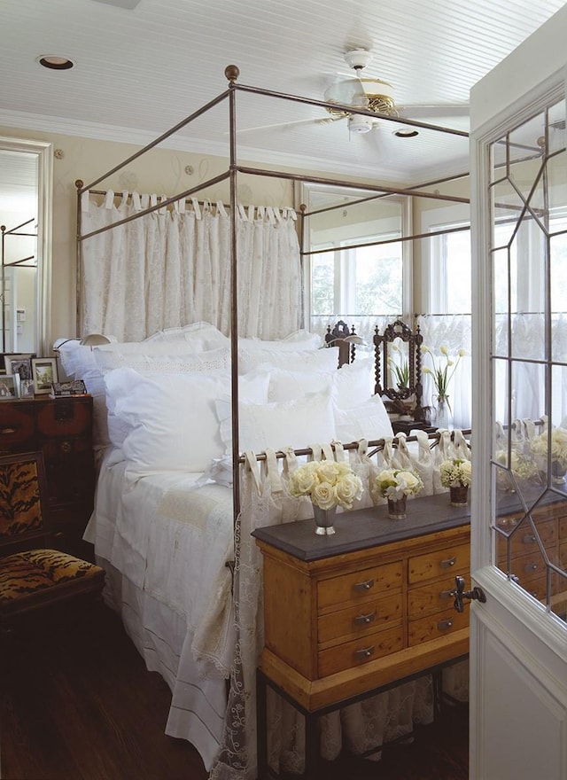 bedroom featuring hardwood / wood-style floors, ceiling fan, and crown molding