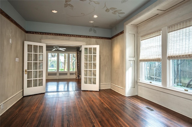 empty room featuring dark hardwood / wood-style flooring, ceiling fan, and french doors