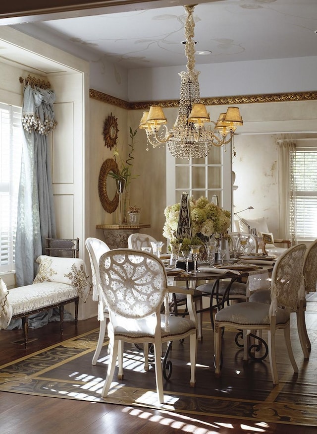 dining space with hardwood / wood-style flooring, an inviting chandelier, and plenty of natural light